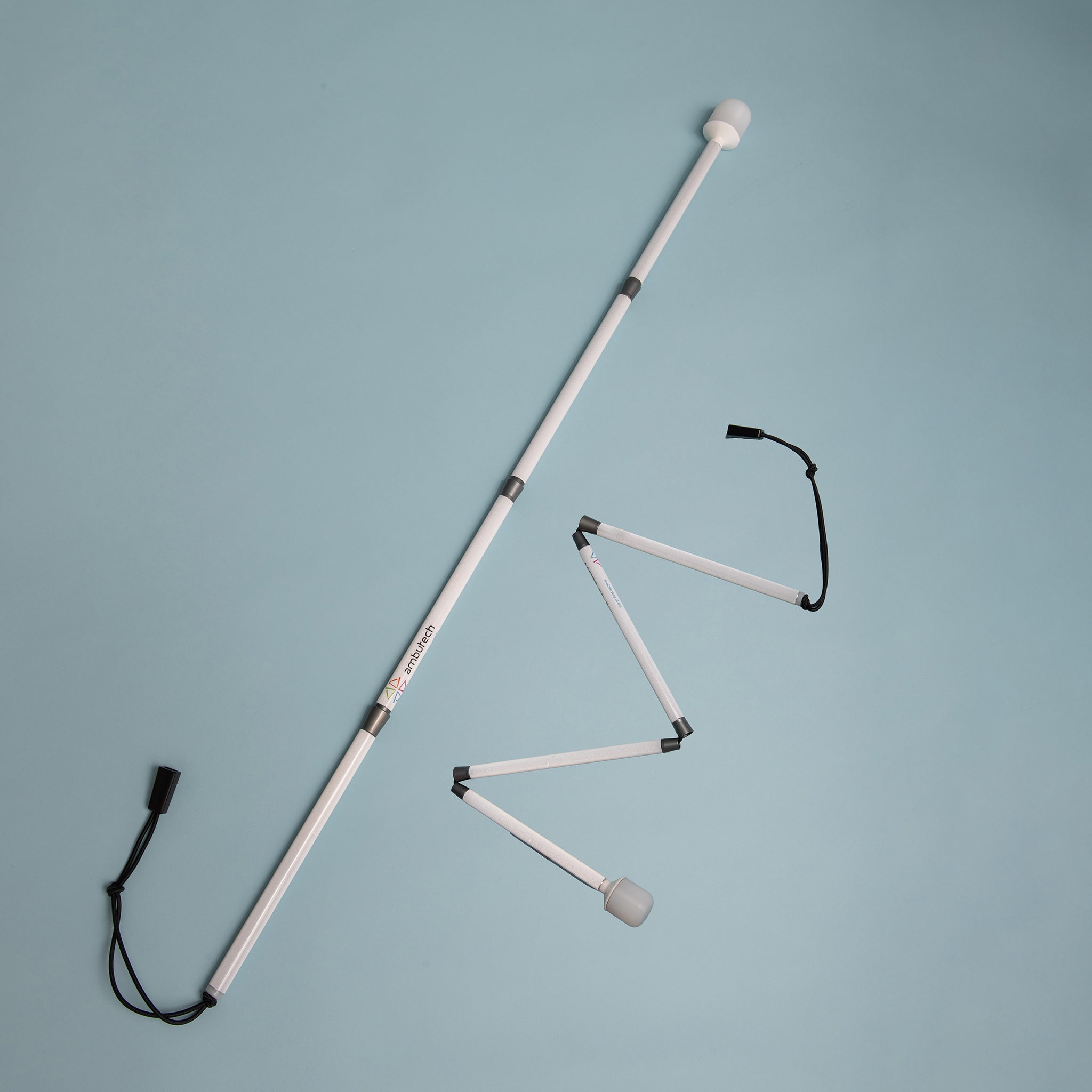 Cane unfolded and partly unfolded on a light background